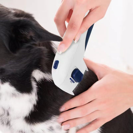 Person using an electric pet comb on a dog, demonstrating easy grooming for shedding fur.