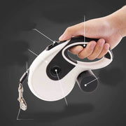 Automatic Retractable Traction Rope for Pets handle featuring ergonomic design for comfort and control during walks.