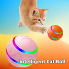 Cat playing with intelligent cat ball, interactive toy for pets in vibrant colors on a playful background.